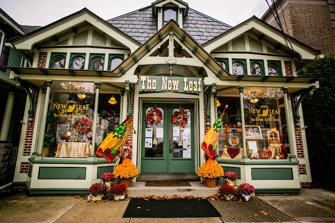 Front of store with fall flags and orange flowers