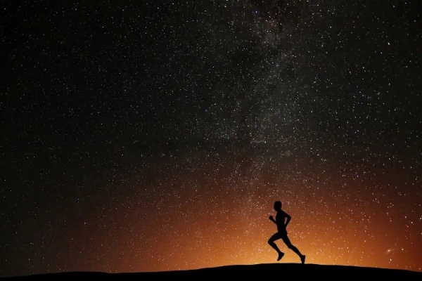 person running under starry night sky