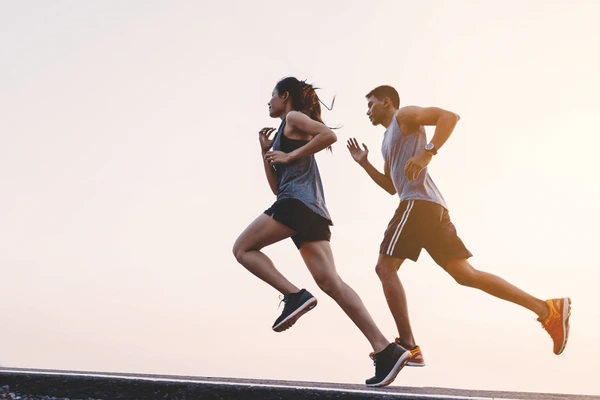 a silhouette two people running