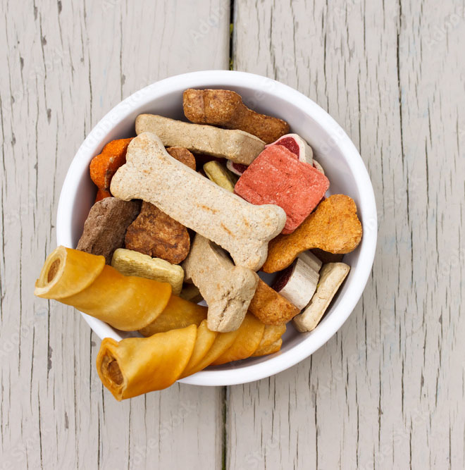 a small bowl of dog treats on a wooden table