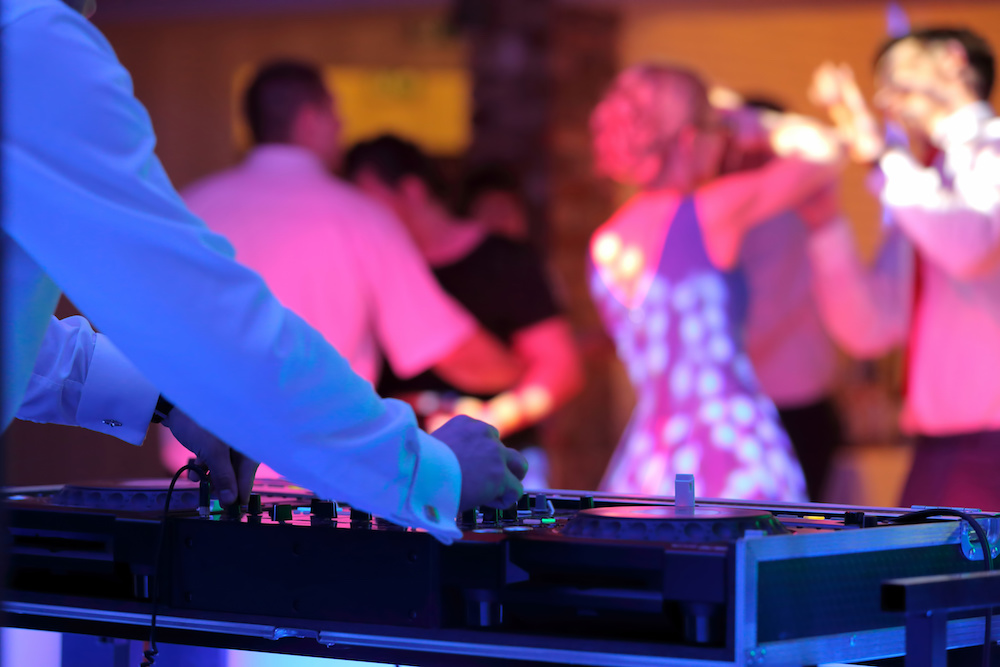 people dancing near a disk jockey
