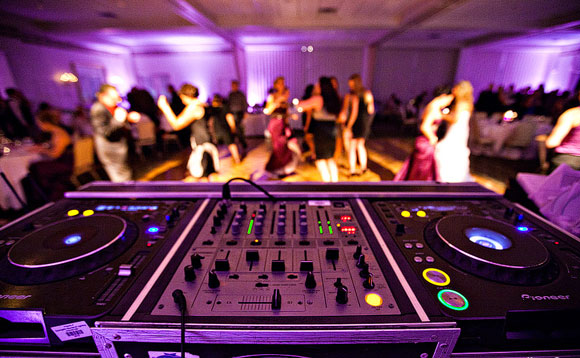 people dancing near a disk jockey set