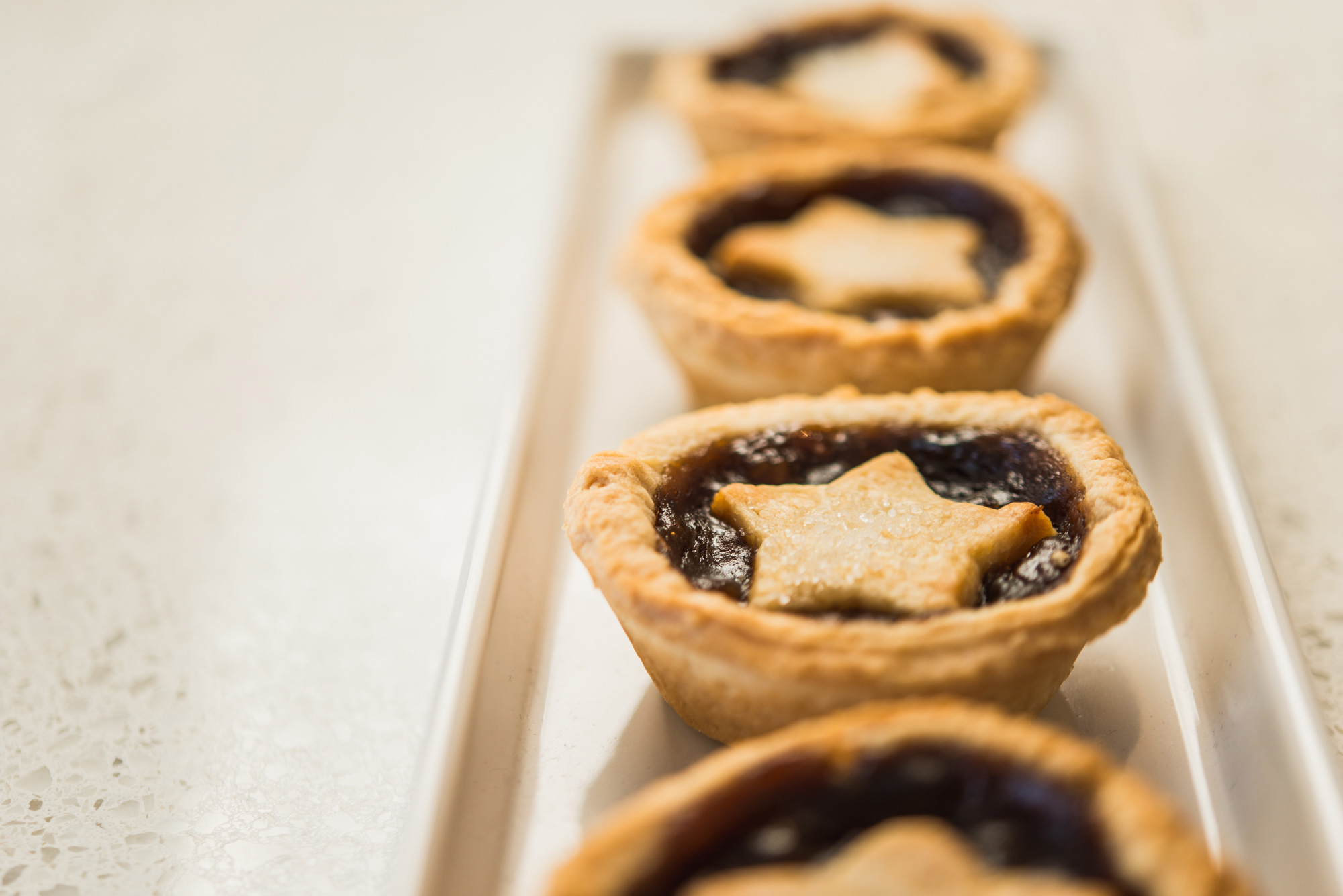 Chocolate filled cookies with star shaped dough on top.