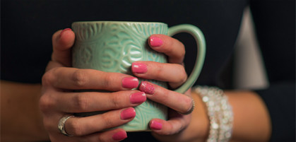 Person holding teal cup